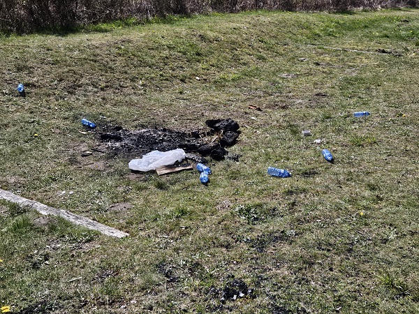 Burnt grass, water bottles and garbage left at Eagle Mountain park in Coquitlam