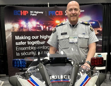 A police officer standing next to a motorcycle