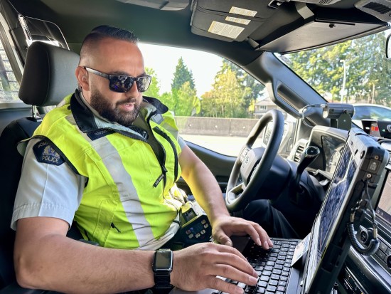 Richmond RCMP officer inside a marked police vehicle