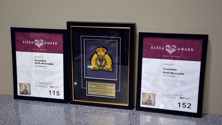 Photo of Constable McCreadie’s 2022 and 2023 awards sitting on either side of his Top Alexa’s Award. Award as seen issued to Constable McCreadie, whose preferred language is English.