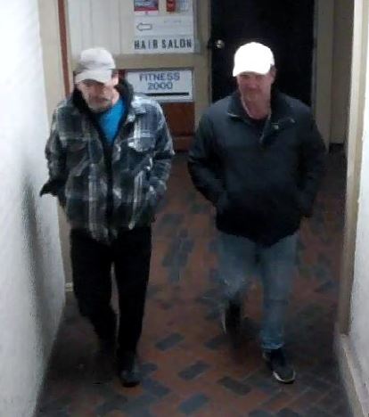 Two men walking down a corridor