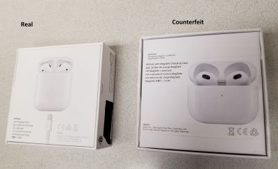 Two boxes of Apple AirPods that look identical. The box on the left is marked as real and the box on the right is marked as counterfeit. 