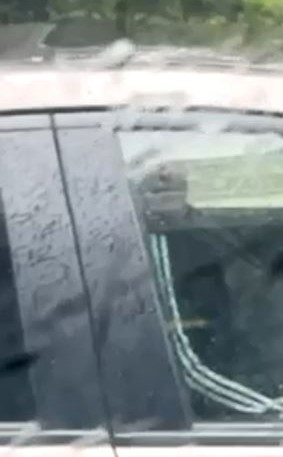 A zoom in image of a suspect in a car