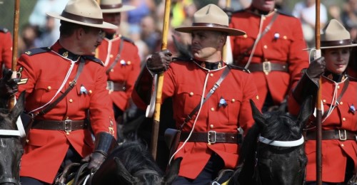 Cpl. Kyle Kifferling on a horse and wearing a Red Serge glances towards a fellow rider during a performance of the Musical Ride 