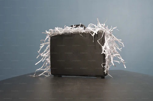 Shredded paper overflowing from briefcase