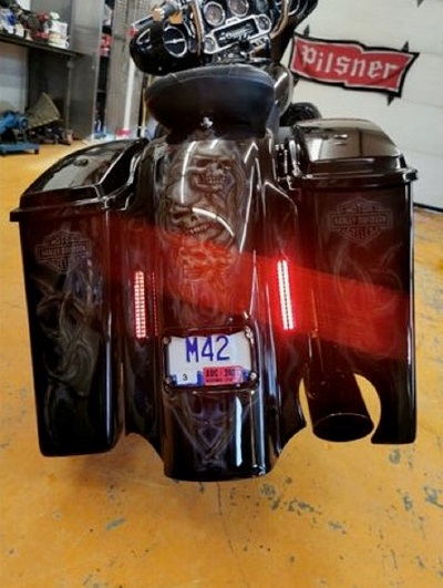 rear end of Harley with airbrushed skulls and antlers and BC licence plate <q>M42</q>