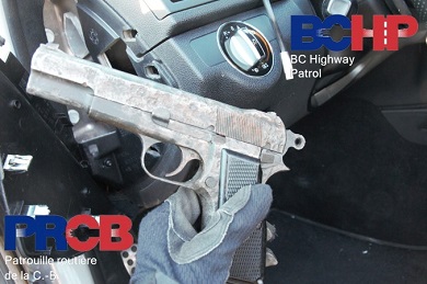 Picture of hand gun with vehicle interior in background