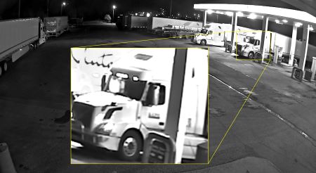 a white Volvo semi truck pulling an Ocean trailer was observed at a service station near Kamloops on Sept. 21, 2021. The photo features an inset of a closeup image of the truck’s cab, which includes a logo on the driver’s side door. 