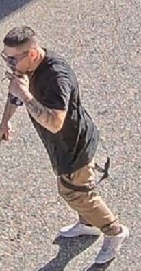  Photo of suspect one wearing a black t-shirt, beige pants and white shoes