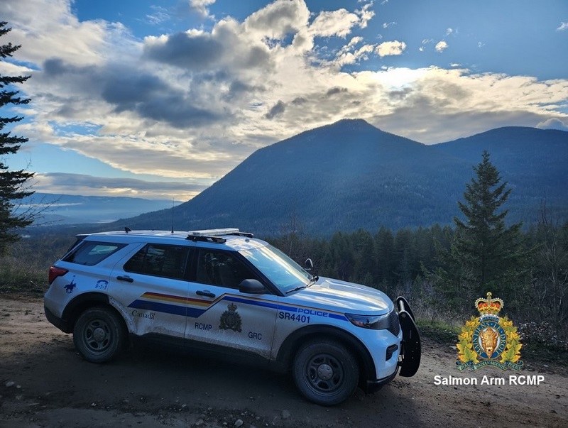 Police vehicle with clouds and mountain in background